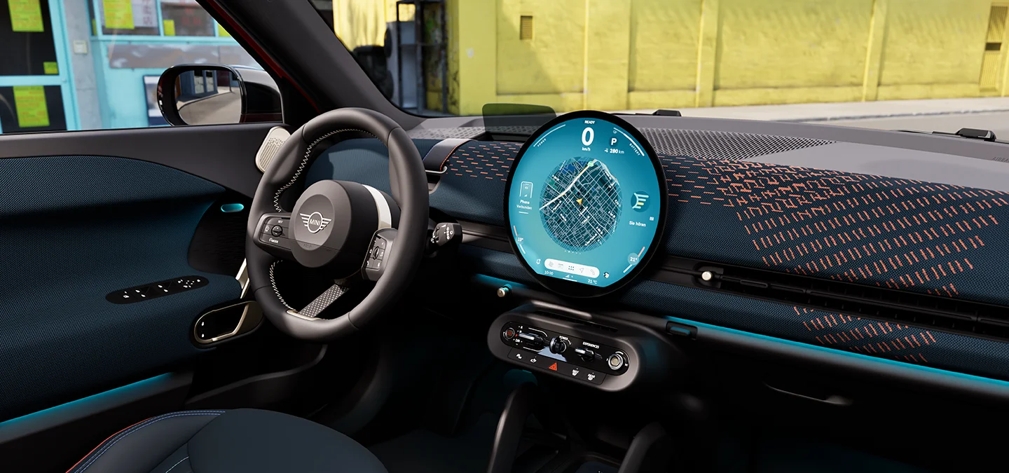 MINI interior with circular infotainment display showing navigation and digital driving information.